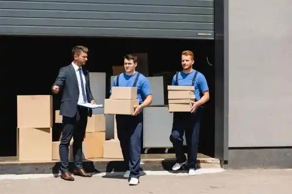 Experienced movers securing household items for transport